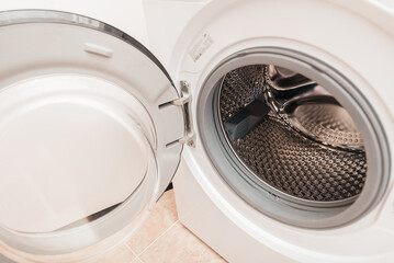 Household machine for washing fabric laundry with an open lid for loading in a household sanitary,...