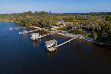 Waterfront villas with private docks at Navarre, Florida. Aerial view of residences with fence...