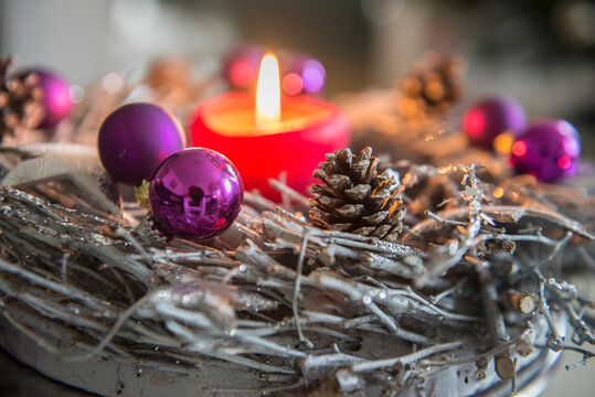 Decorative advent wreath with burning candle, Bavaria, Germany