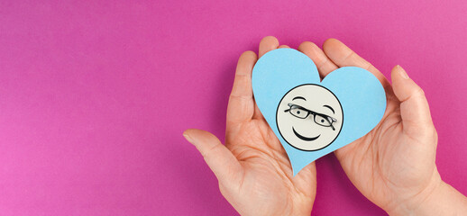 Heart with a smiling face and eyeglasses, mental health concept, positive mindset, support and...