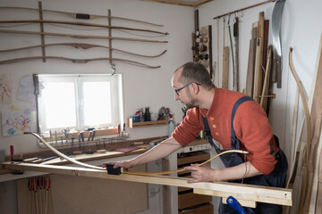 Male bow maker making bow in workshop, Bavaria, Germany