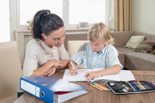 Woman helping her son with his homework, Bavaria, Germany