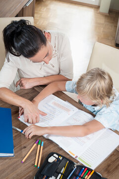 Woman helping her son with his homework, Bavaria, Germany