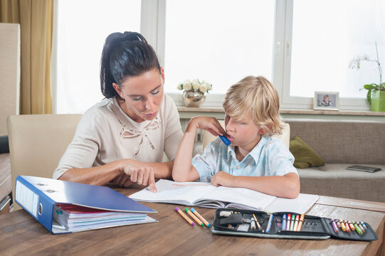Woman helping her son with his homework, Bavaria, Germany