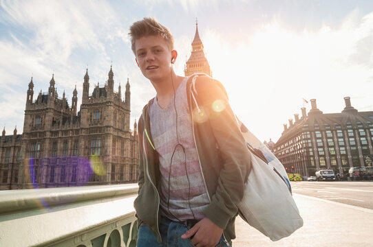 Portrait of boy in front of city buildings, London, England