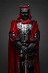 Portrait of knight member of mystic cult with mask holding sword.