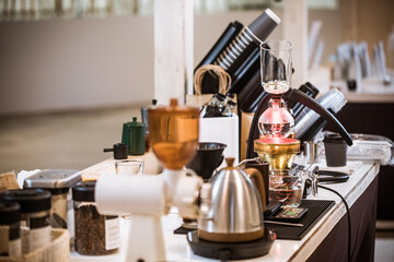 Professional coffee maker - Barista using coffee siphon brewing hot espresso at coffee shop coffee brewing syphon alternative method. Startup Business Concept.