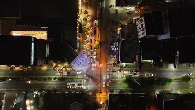 Downtown Center mall illuminated at night in Santo Domingo city, Dominican Republic. Aerial top-down forward directly above