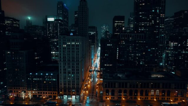 futuristic aerial of chicago night time 4k. Covered by mist after got rained. Cyan moody feel