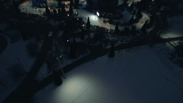 Glide into the winter wonderland at Maggie Daley Skating Ribbon - an ice skating loop surrounded by the stunning cityscape and majestic scenery of downtown Chicago. Aerial night chicago 4k