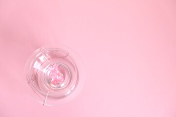 Children's  jewelry in the form of a bear on a pink background. Jewelry, costume jewelry.