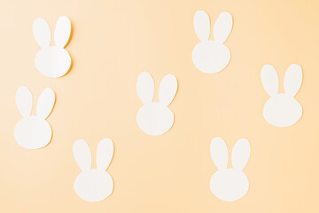Easter Day Concept. Top view handmade white paper rabbit cutting isolated on pastel background with copy space for your text, Happy Easter Bunny holiday