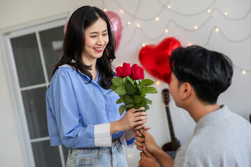 Couple in love hugging in the bedroom with rose and gift Valentine's Day  concept.