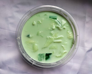 Selective focus. Buko Pandan is a dessert originated from the Philippines. Made of jelly, young coconut and whip cream. Best served cold.
