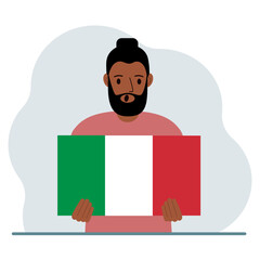 A man holds an Italian flag in his hands. The concept of demonstration, national holiday or patriotism.