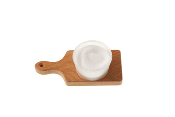 Isomaltitol or Isomalt powder in plastic container on wooden board isolated on white. Food additive E963, sweetener, sugar substitute used in food industry. Confectionery ingredient