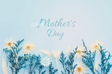 mother's day concept with blue flowers over pastel background