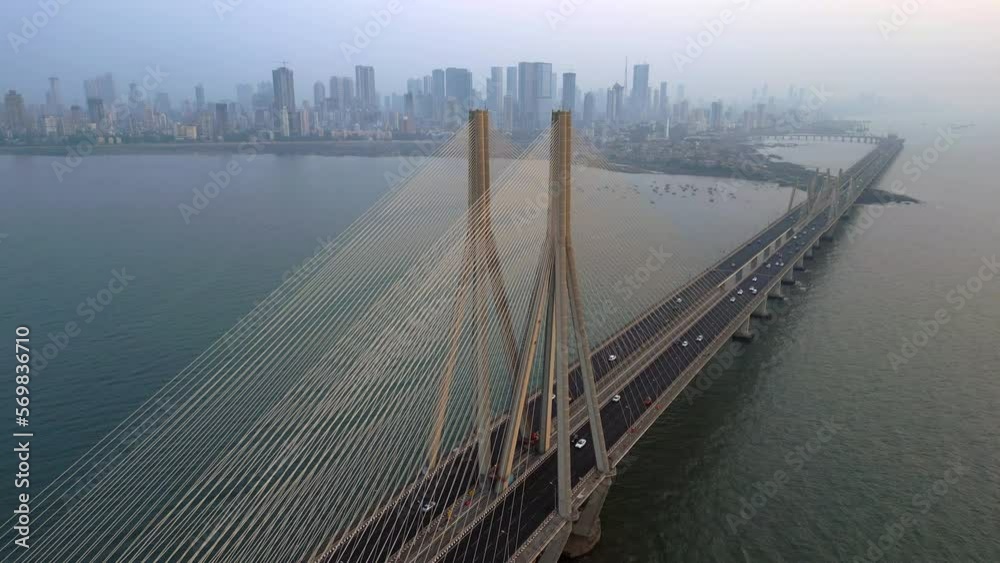 Wall mural Aerial view of traffic on the Bandra Worli Sea Link cable stayed bridge with the Mumbai skyline in the background in Mumbai, Maharashtra, India.