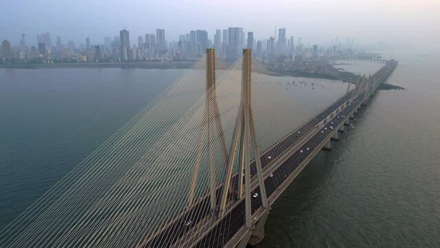 Aerial view of traffic on the Bandra Worli Sea Link cable stayed bridge with the Mumbai skyline in the background in Mumbai, Maharashtra, India.