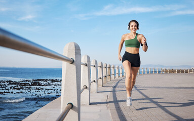 Running, music and woman at beach for fitness, exercise and morning cardio with energy in sports....
