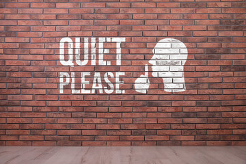 Phrase Quiet Please and shush gesture image on red brick wall
