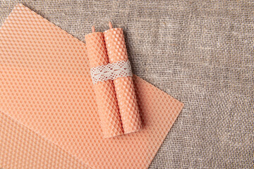 Colored wax sheet and beeswax candles. Space for text. Handmade pink candles