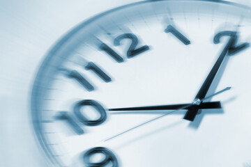 Fleeting time concept. Clock on light background, closeup. Motion effect