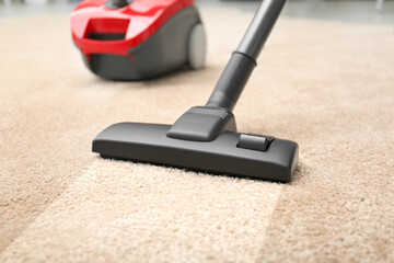 Vacuuming dirty beige carpet. Clean area after using device, closeup