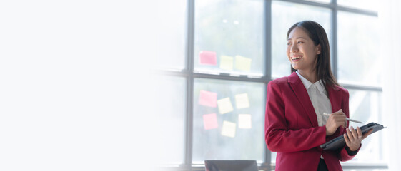 Young pretty attractive asia chinese half thai woman mixed race working with online balance sheet, online bookkeepers helpful consult accounting reports and financial statements. using tablet pc © NanSan