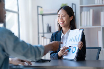 Meeting and consulting agenda of indian asia mixed race business man and female china half thai ethnicity bookkeepers discussing assets, balance sheet, stock market profit with yearly tax. © NanSan