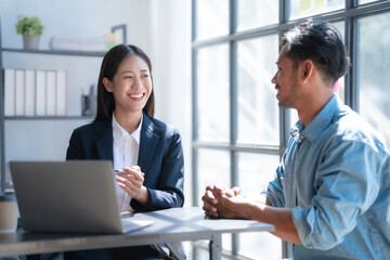 Pointing laptop, Meeting and consulting agenda of indian asia mixed race business man and female china half thai ethnicity bookkeepers discussing balance sheet, stock market profit with yearly tax.