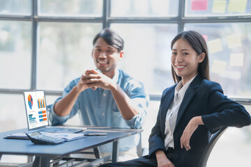 Pointing laptop, Meeting and consulting agenda of indian asia mixed race business man and female china half thai ethnicity bookkeepers discussing balance sheet, stock market profit with yearly tax. © NanSan