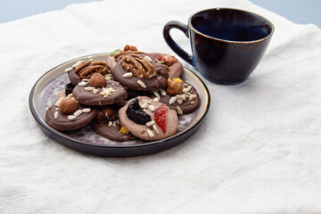 French sweets on plate. Handmade candies with nuts and berries. Sweets for tea or coffee