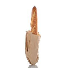 One aromatic baguette in a paper bag, macro isolated on white background.