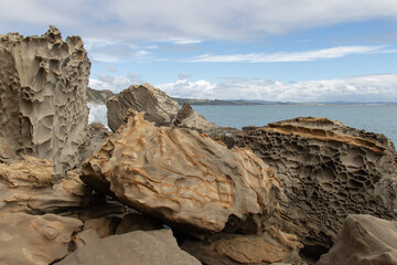 Coastline with big rocks and blue sea on background, Auckland, New Zealand.