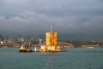 Sunset on the Bosphorus and restoration of the Maiden's Tower. Sunset view from the sea in Istanbul