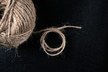 Close-up of a ball of twine rope on a dark background. Selective focus.