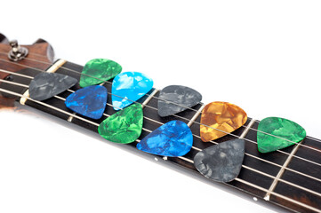 Plastic picks of different colors for playing acoustic or electric guitar.