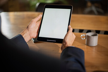 Close up of man using digital tablet..