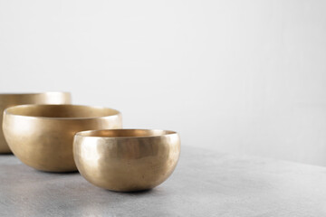 Tibetan singing bowls on stone table background