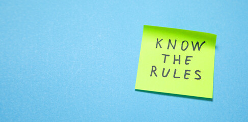Know The Rules on sticky note on the blue background.