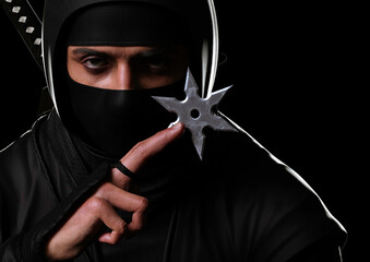 Close-up of a ninja holding a shuriken in the dark. Traditional ninja style. 3d illustration.