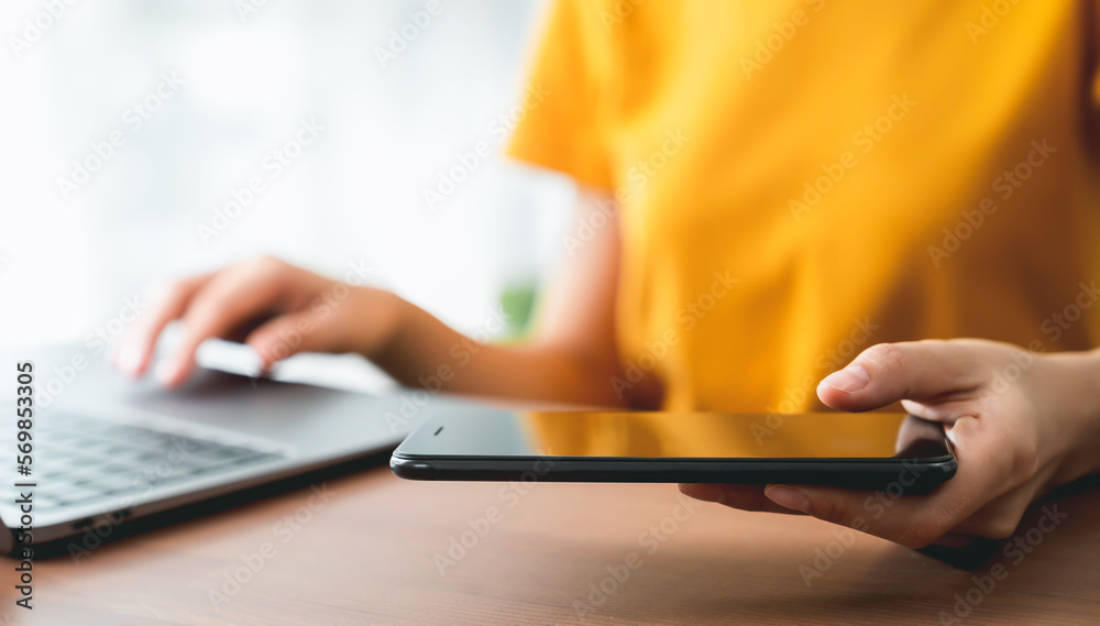 Sticker Hand holding smartphone and using laptop.