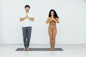 Obraz premium a woman and man doing yoga does stretching exercises for the body female exercises
