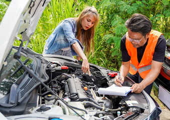 Fototapeta na wymiar Closeup auto mechanic checking for breakdowns and list repairs according to customer orders