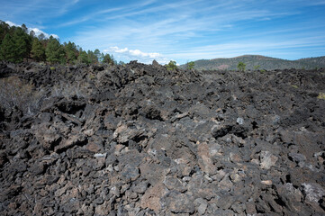 Mountainous landscape of Sunset Crater Volcano National Monument, it is a desolate volcanic area, with some trees