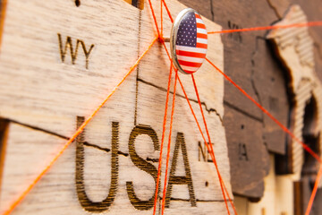 USA flag pins and red thread for traveling and planning trips. Planning of logistics routes or...
