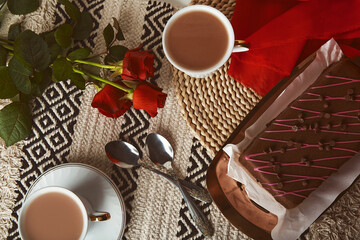 Valentines day breakfast with chocolate cake, coffee cups and red roses aesthetics flat lay