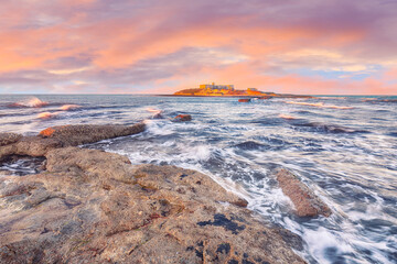 Dramatic morning scene of awesome spring seascape on the Passero cape Sicily.