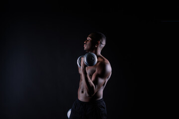 Portrait of a happy african man with dumbbells over red background